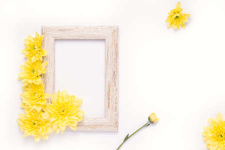 Wooden photo frame with aster flowers on a white background. Copy spaceの写真素材