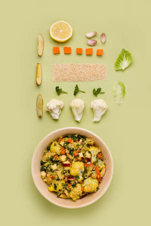 Salad with cauliflower, quinoa, apple on a green background. knollingの写真素材