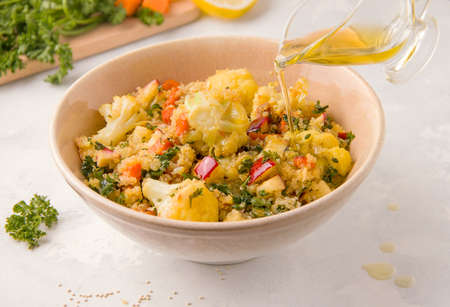 Vegetarian salad with quinoa and cauliflower on a light backgroundの写真素材