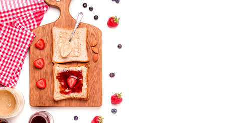 Sweet breakfast with Peanut butter and jelly sandwich on a white plate. Copy spaceの写真素材