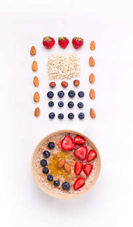 healthy breakfast of porridge with berries on a white plate. in knolling styleの写真素材