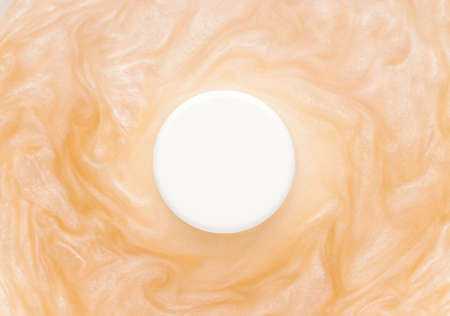 Mockup of cosmetic products. White round bottle in water with shimmerの写真素材