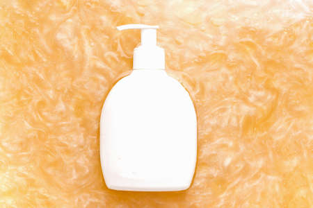 Mockup cosmetics. White bottle in water with a shimmer. View from aboveの写真素材