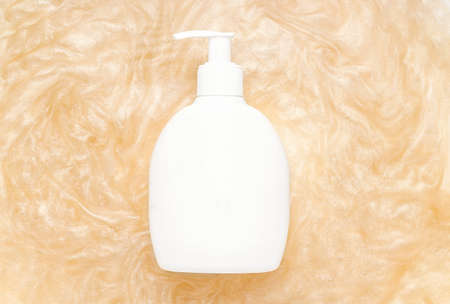 Mockup of beauty care products in shimmer. White bottle with glitter dispenserの写真素材
