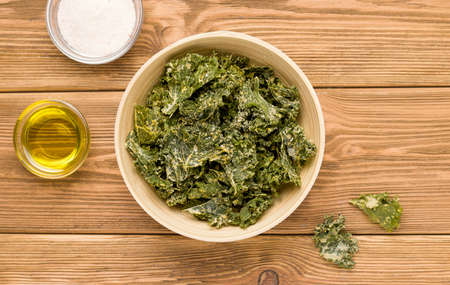 Kale chips on a wooden table. View from above. Rusticの写真素材