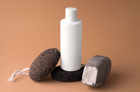 Mockup of a white bottle on a pedestal of stones. Cosmetics conceptの写真素材