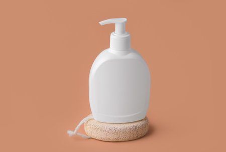 Makeup mockup. White bottle with dispenser, on a beige backgroundの写真素材