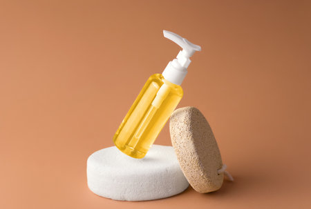Mockup of transparent cosmetic oil bottle on a stone pedestalの写真素材