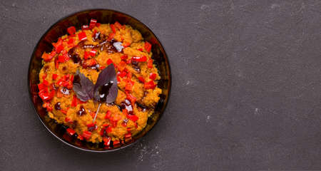 Vegetarian soy meat dish with vegetables and basil on a black background. Copy spaceの写真素材