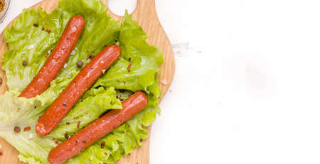 Vegetarian meat concept. Soy and spice sausages on a lettuce leaf. Copy space top viewの写真素材