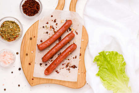 Vegan sausages with spices and tomato on a white plate. Copy space.の写真素材
