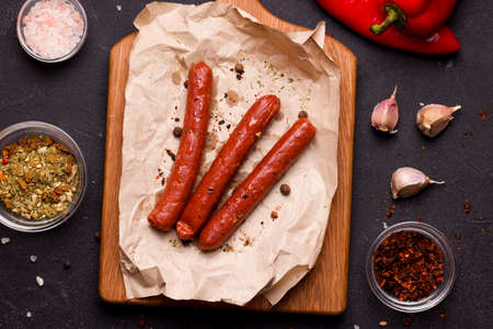 Vegetarian food concept. Soy sausages with spices and dried tomato on a black backgroundの写真素材