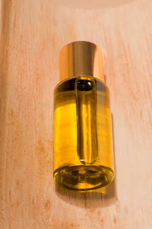Cosmetic organic oil closeup on wood texture.の写真素材