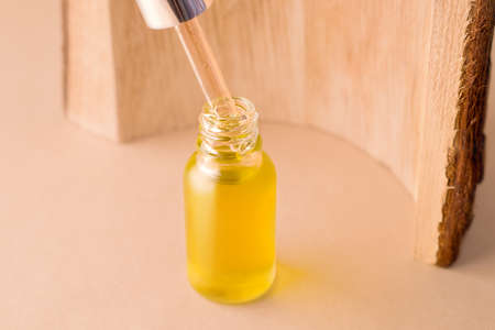 Organic cosmetic oil on beige backgroundの写真素材