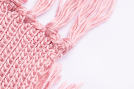 Pink knitted warm scarf on a white background. View from above. Copy spaceの写真素材
