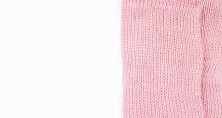 Knitting concept. Warm pink scarf on a white background. Copy space. View from aboveの写真素材