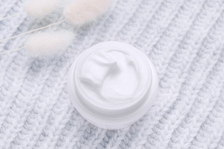 Open jar of cream top view. Gray background. Winter skin care cosmetics conceptの写真素材