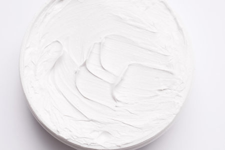 Body and face care cream. Close-up texture. View from above. White backgroundの写真素材
