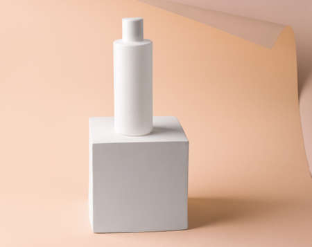 Mockup of gel, shampoo on a pedestal from a cube on a paper backgroundの写真素材