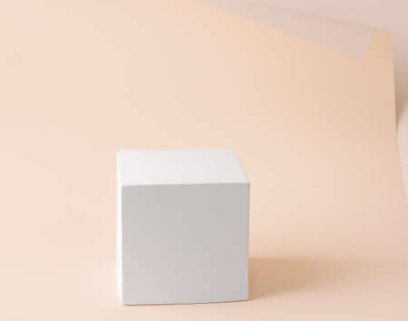 White cube pedestal on paper backgroundの写真素材