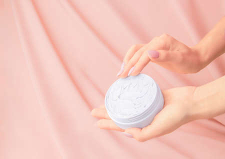 Open cream on beige silk backgroundの写真素材