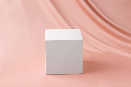 Cube platform on a beige, silk background. Abstract blank mock up background conceptの写真素材