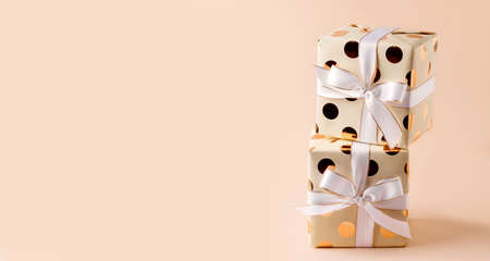 Two wrapped gifts on a beige background. Copy space. Bannerの写真素材