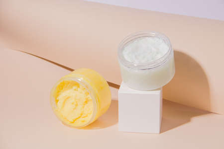 Face and body scrub on a beige paper background. Modern styleの写真素材