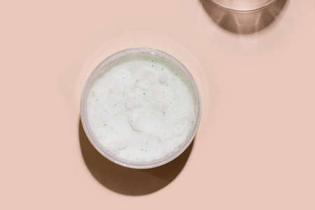 Body scrub cosmetics on beige background. View from aboveの写真素材