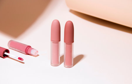 A set of nude lipsticks on a beige background. Copy spaceの写真素材