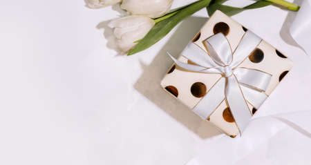 Gift wrapped box light on a white background. Copy spaceの写真素材