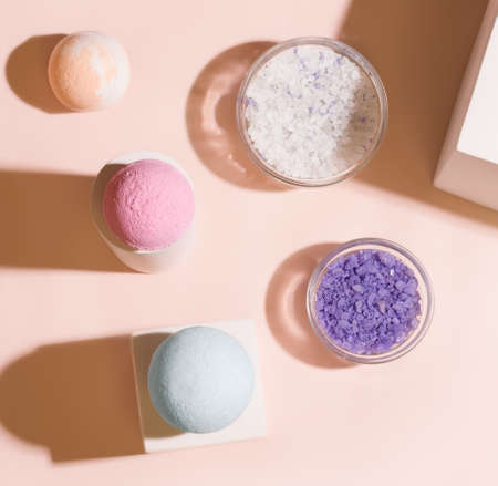 Bathing set. Bath salt bombs on a cream background. View from aboveの写真素材
