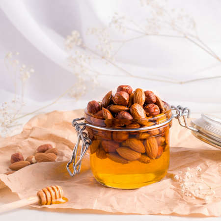 Foods that are useful for the immune system. Honey with nuts on a white backgroundの写真素材