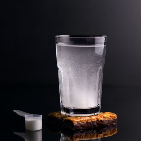 Healthy drinks for athletes. White drink in a glass on a black background.の写真素材