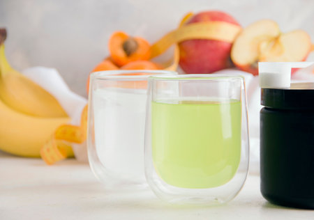 White and green fitness drinks on light backgroundの写真素材