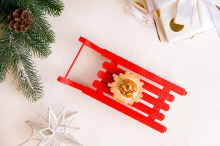 Sweet cookies on a red New Year's sleigh. Festive food concept. View from above.の写真素材