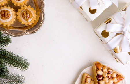 Background for new year or christmas. Cookies, Christmas tree, gifts on a white tableの写真素材