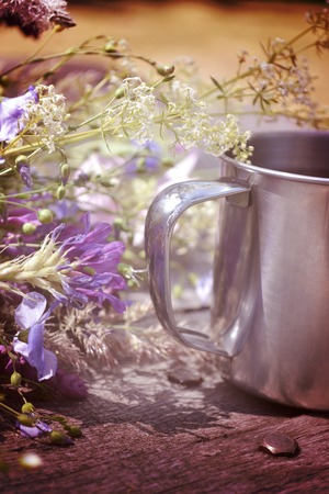 mug on the table, next to lay fresh flowersの写真素材