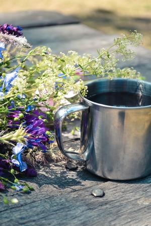 mug on the table, next to lay fresh flowersの写真素材