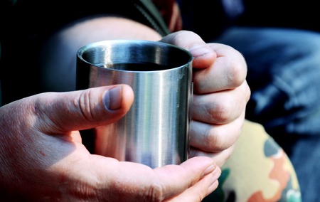 man holding a metal cup closeup, filter,の写真素材