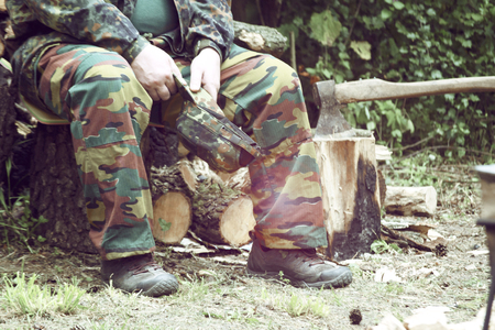 man in camouflage sitting in the forest, filter,の写真素材