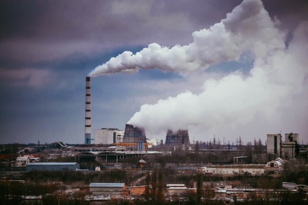 Factory with smoking chimneys in cloudy weather, filterの写真素材