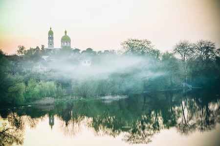 landscape church river fog at dawn, sunsetの写真素材
