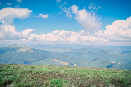 bright landscape of the Carpathian Mountains with blue sky and white cloudsの写真素材