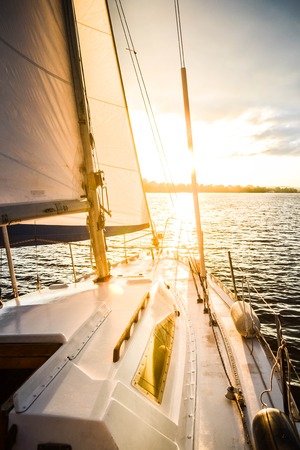 Yacht on the water at sunset, dawn with filterの写真素材
