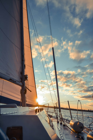 sail sailing ship on the water and the sky with clouds wih filterの写真素材
