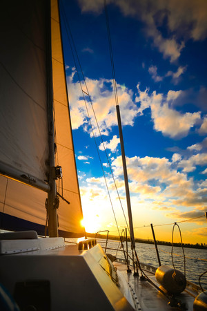sail sailing ship on the water and the sky with clouds wih filterの写真素材