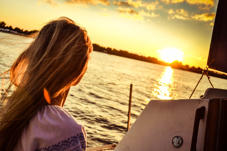 girl on the boat watching the sunset with filterの写真素材