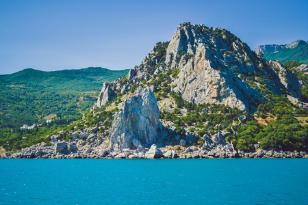 mountains, rocks of the island of Crimea in the summer on a sunny day, the view from the seaの写真素材