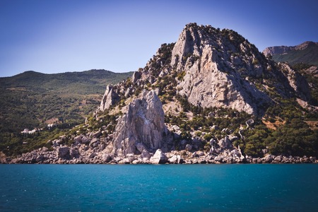 mountains, rocks of the island of Crimea in the summer on a sunny day, the view from the seaの写真素材